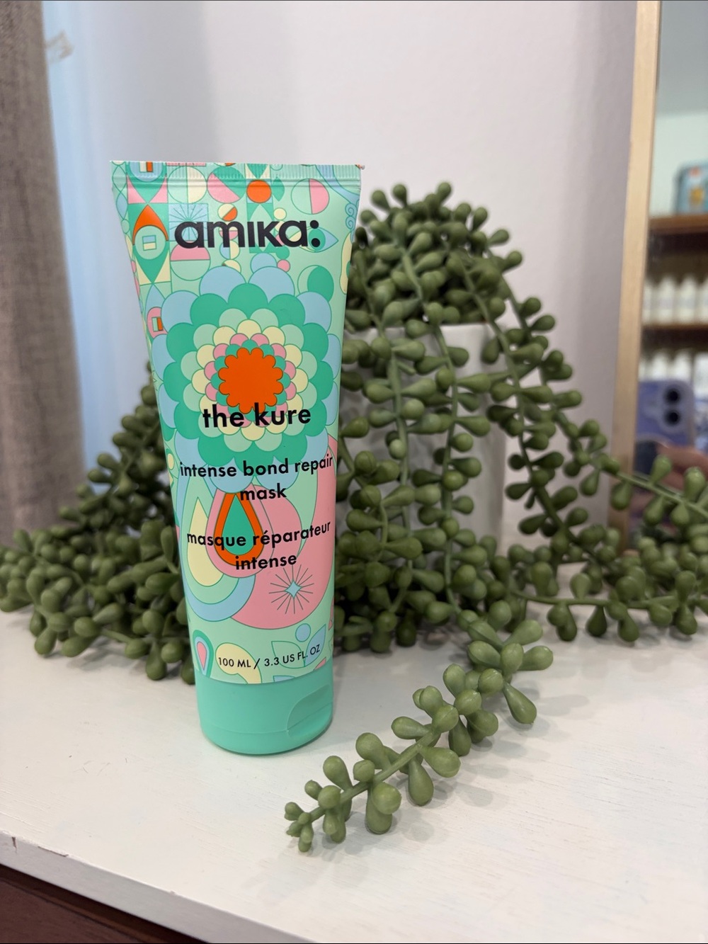 amika Mint Green Bond Repair Hair Mask with Colorful Floral Graphic